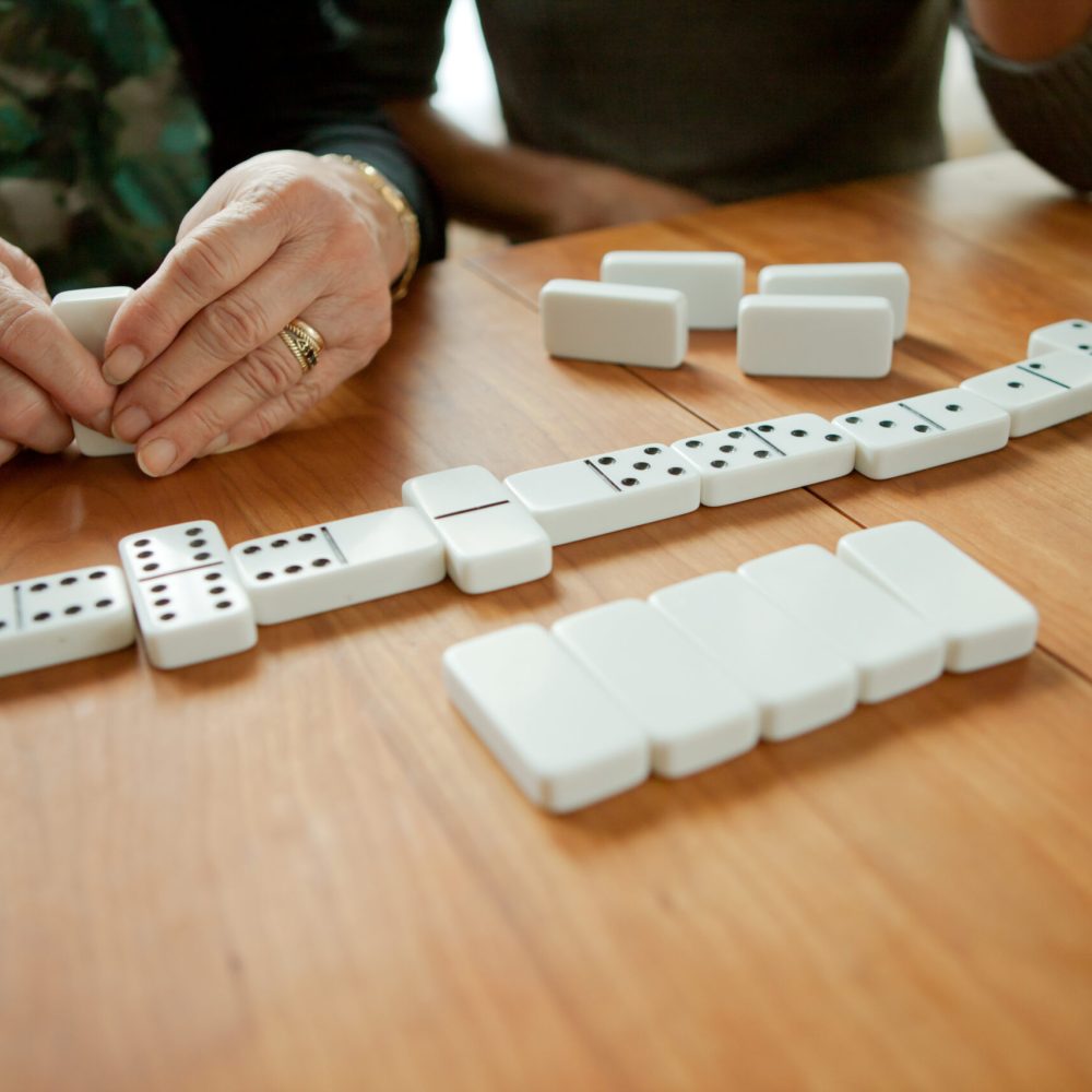 Mother and adult daughter playing dominoes